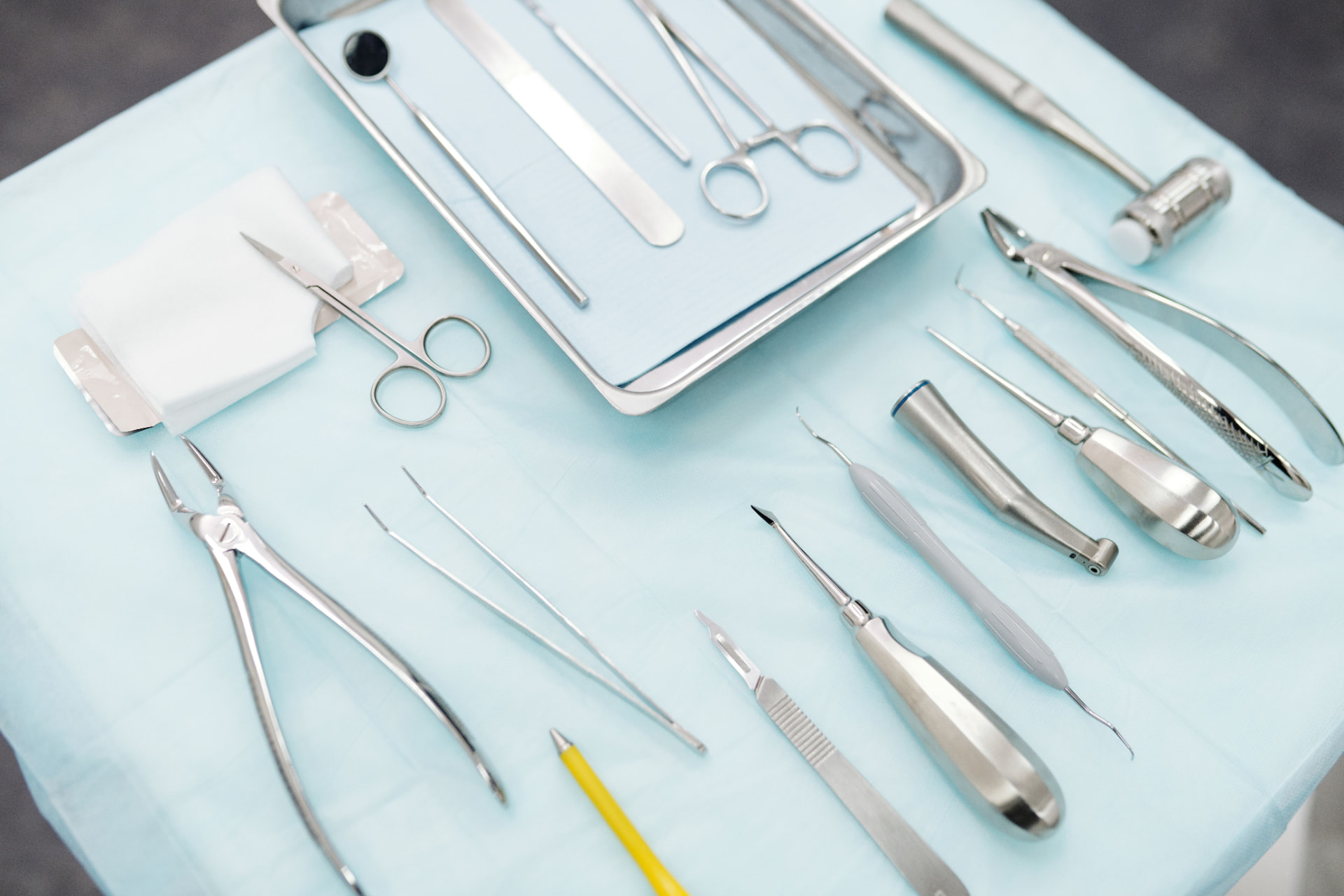 Stainless steel instruments laid out on a sterile tray for inspection