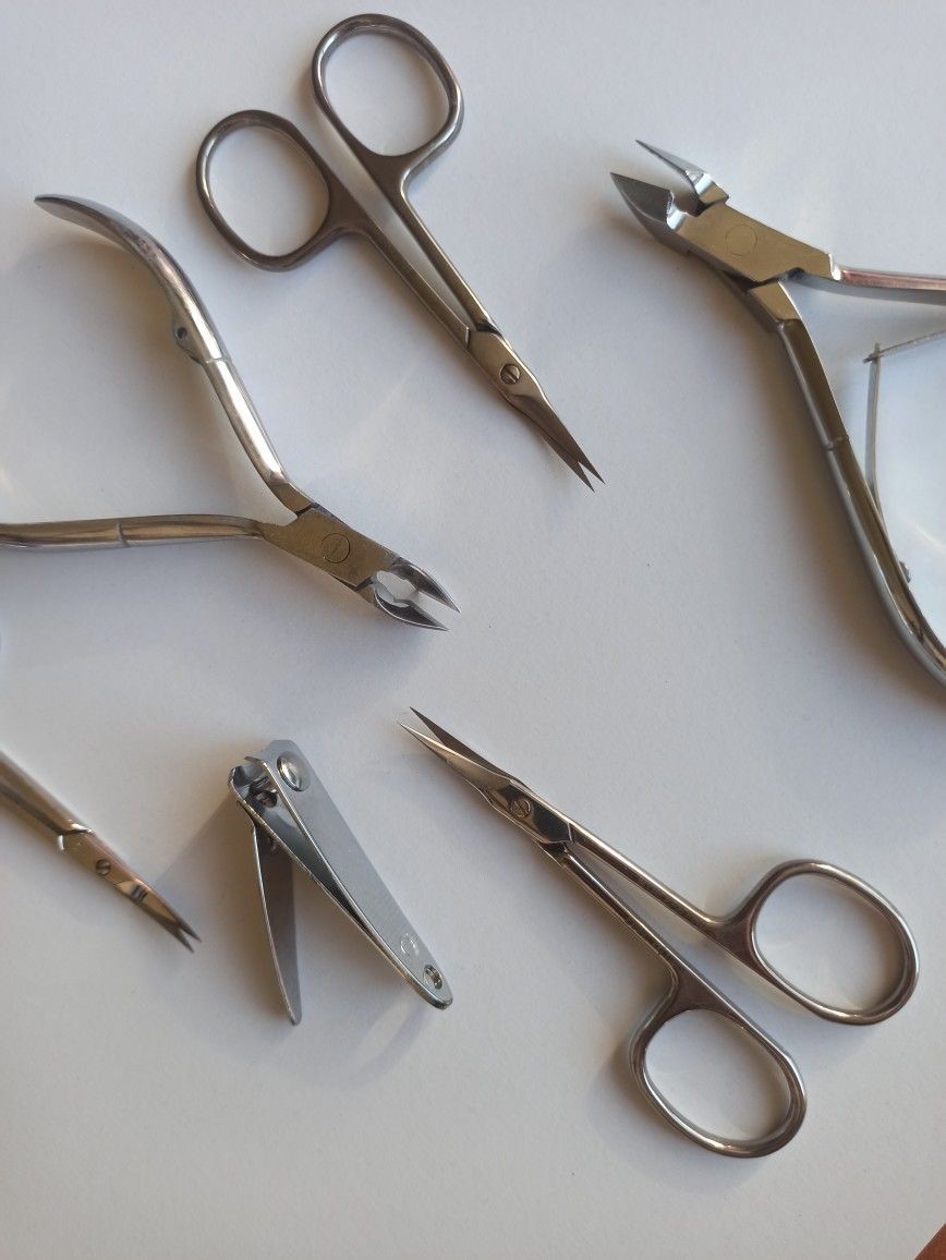Cuticle nippers, curved cuticle scissors and a nail clipper