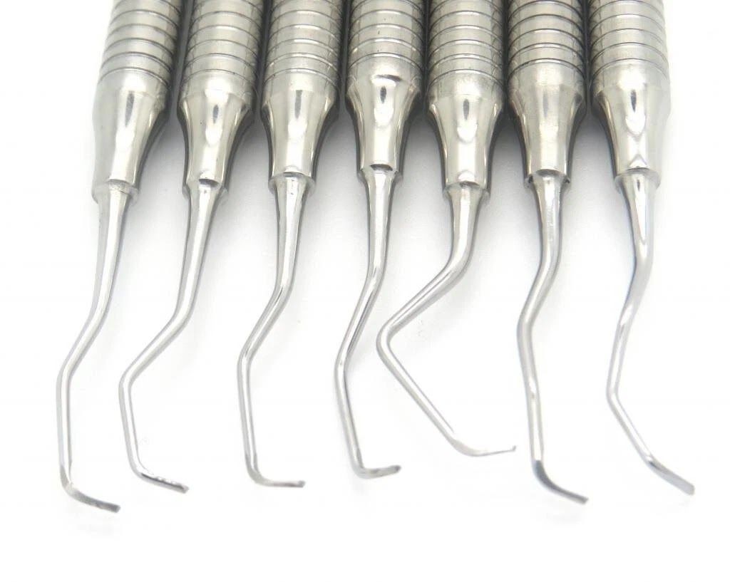 Set of dental scalers and curettes with ribbed hollow handles and angled working tips
