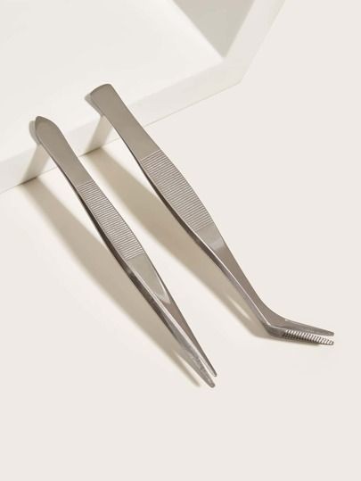 Two stainless steel eyebrow tweezers — straight point and angled serrated tip